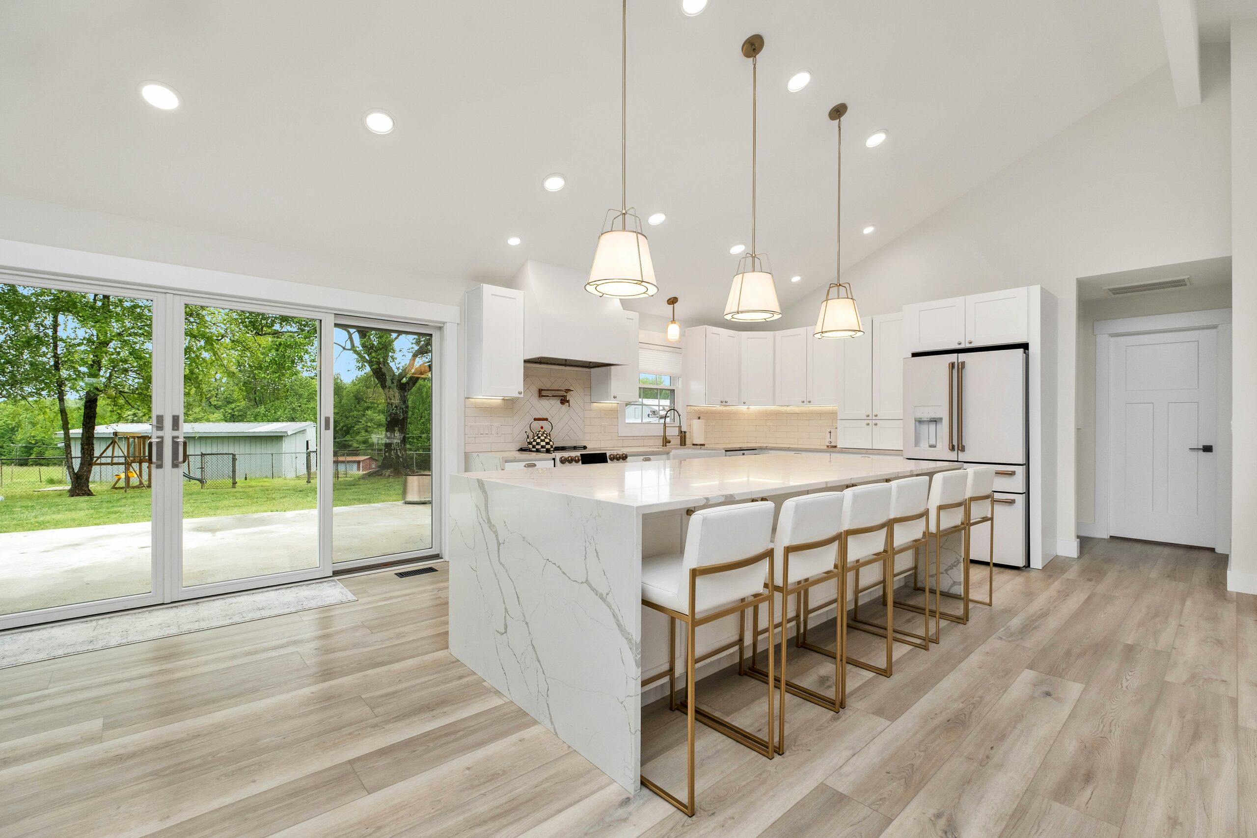 Modern kitchen and living room remodel with upgraded flooring and lighting in Florida home.